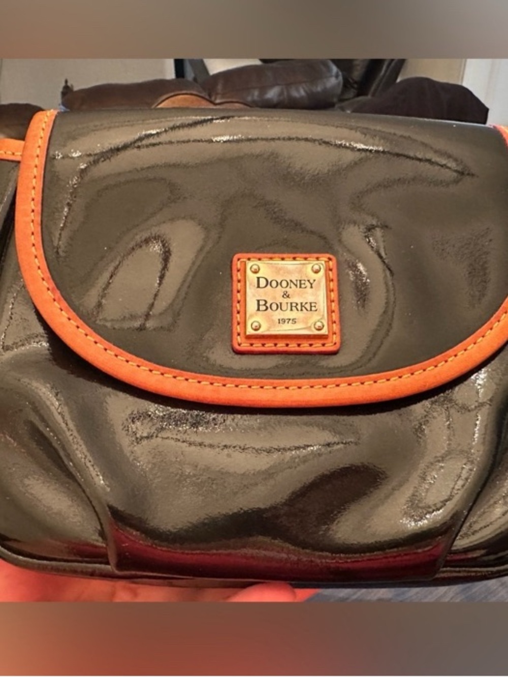 Dooney & Bourke Black Patent Crossbody with Orange Trim and Logo Plaque